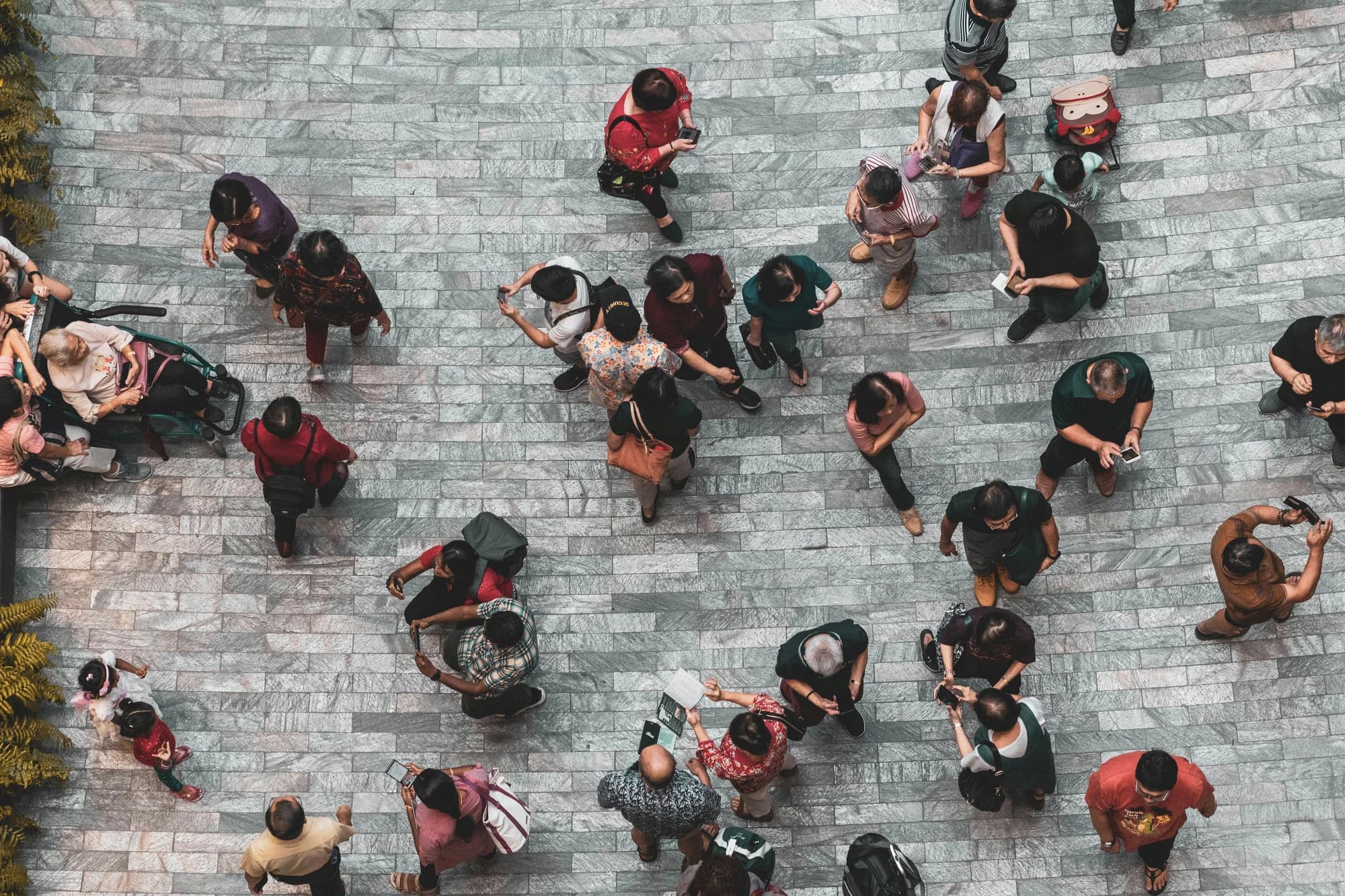 People seen from directly above on a patterned stone plaza